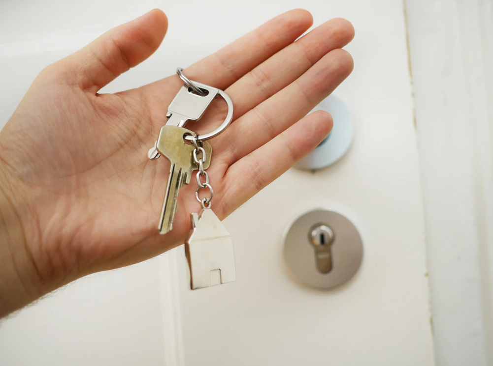 hand with keys near door